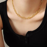 a woman wearing a black shirt and a gold necklace
