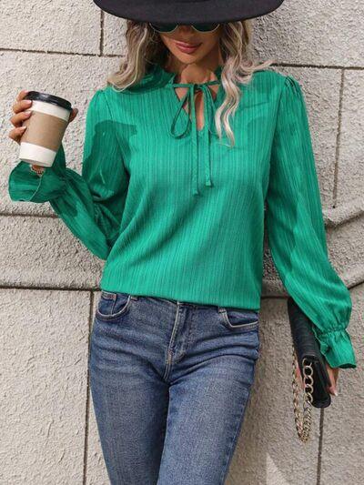 a woman wearing a hat and holding a cup of coffee