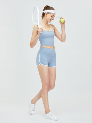 a woman holding a tennis racquet and a tennis ball