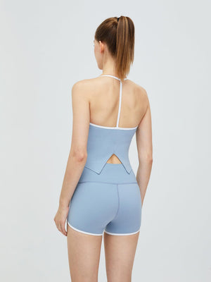 the back of a woman wearing a light blue bodysuit