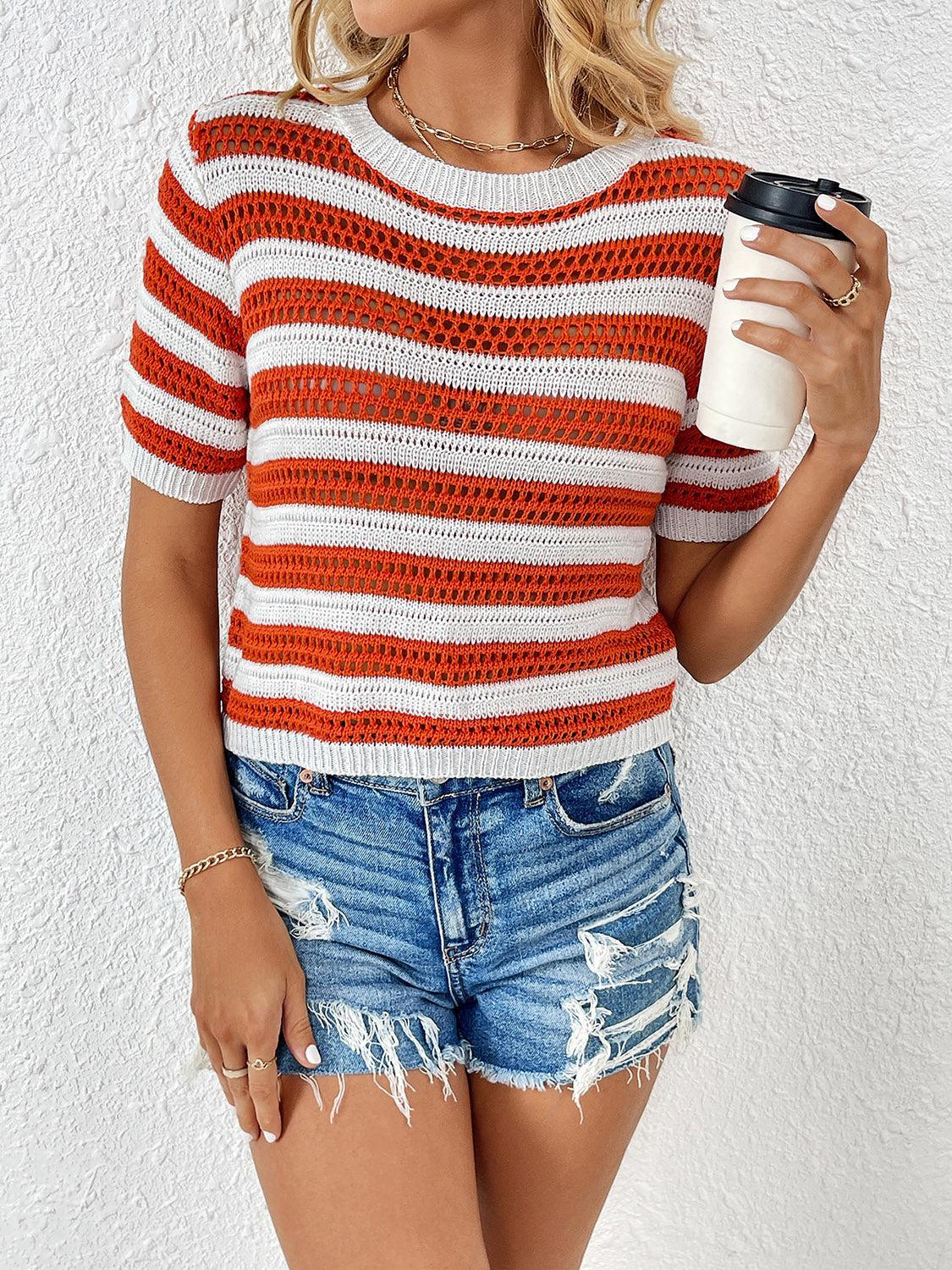 a woman in a striped sweater holding a cup of coffee