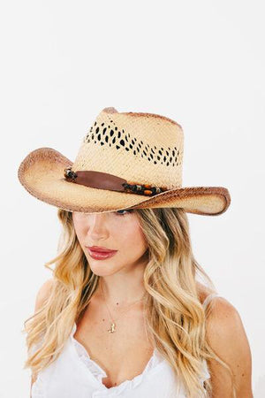 a woman wearing a cowboy hat and white shirt