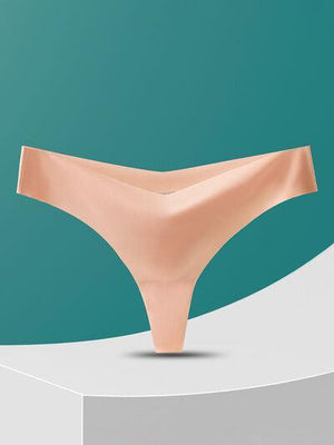 a woman's panties on a pedestal against a teal background