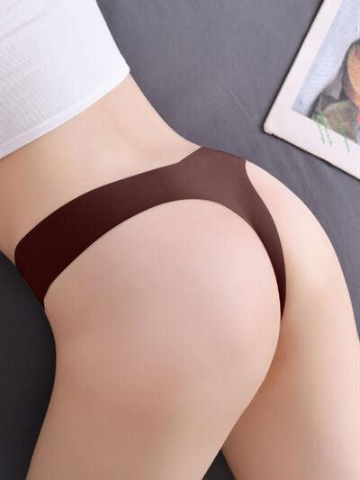 a woman's butt with a brown thong on