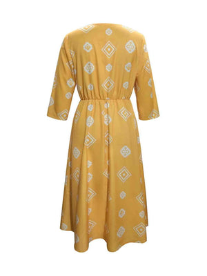 a yellow dress with a white pattern on it