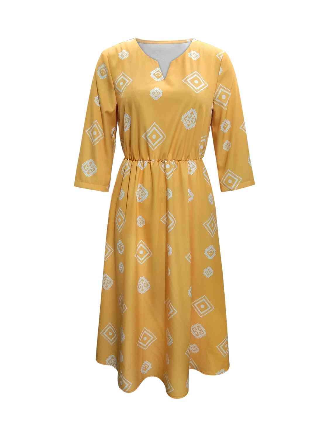 a yellow dress with a white pattern on it