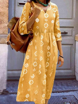 a woman in a yellow dress is standing in front of a door