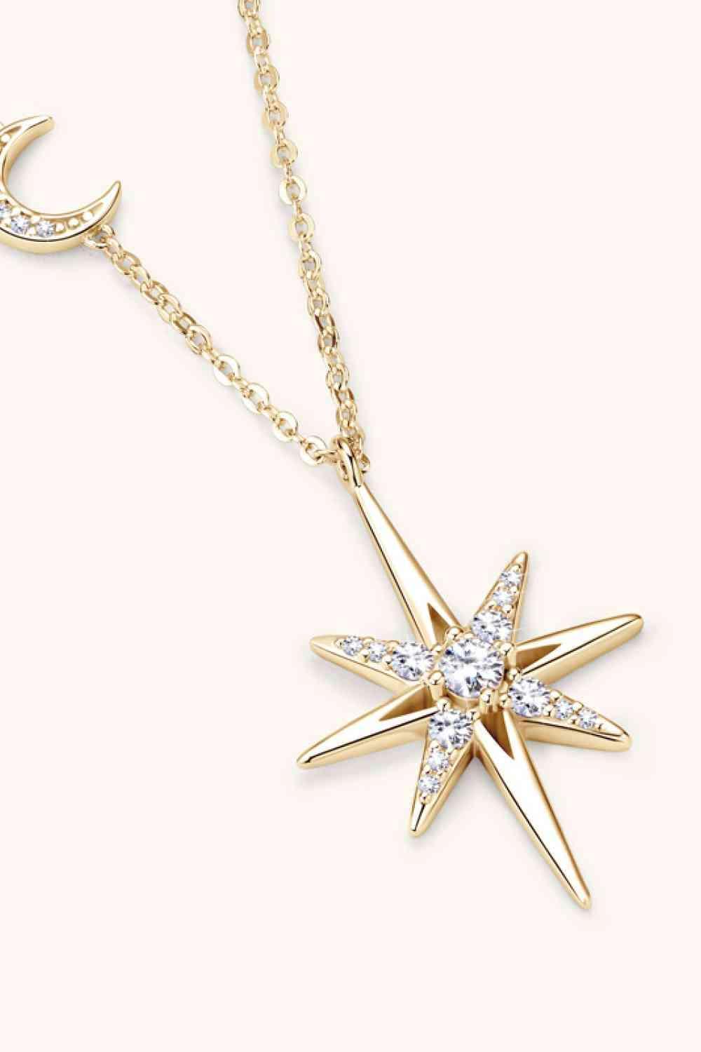 a gold necklace with a star and a crescent
