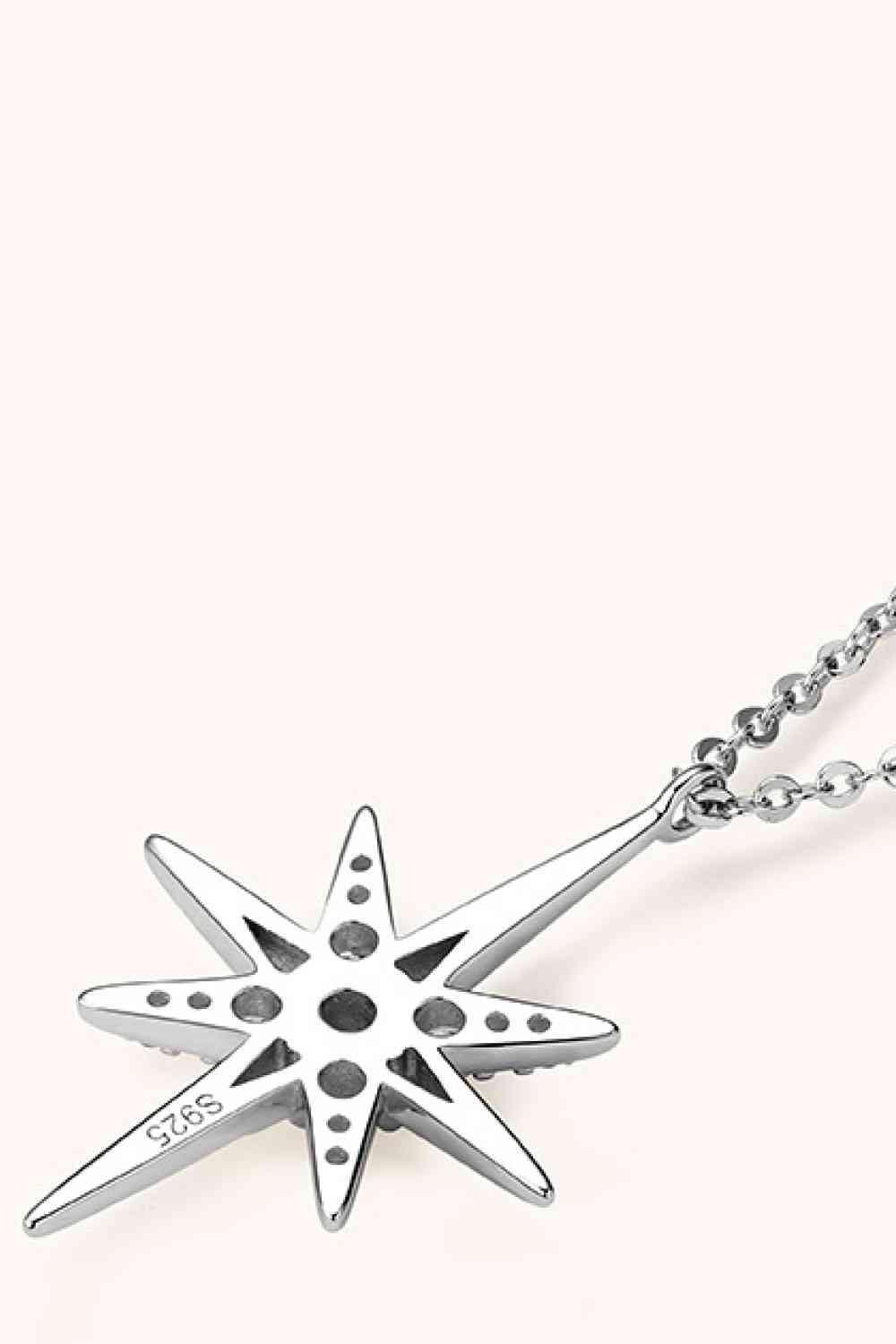 a silver necklace with a star on it