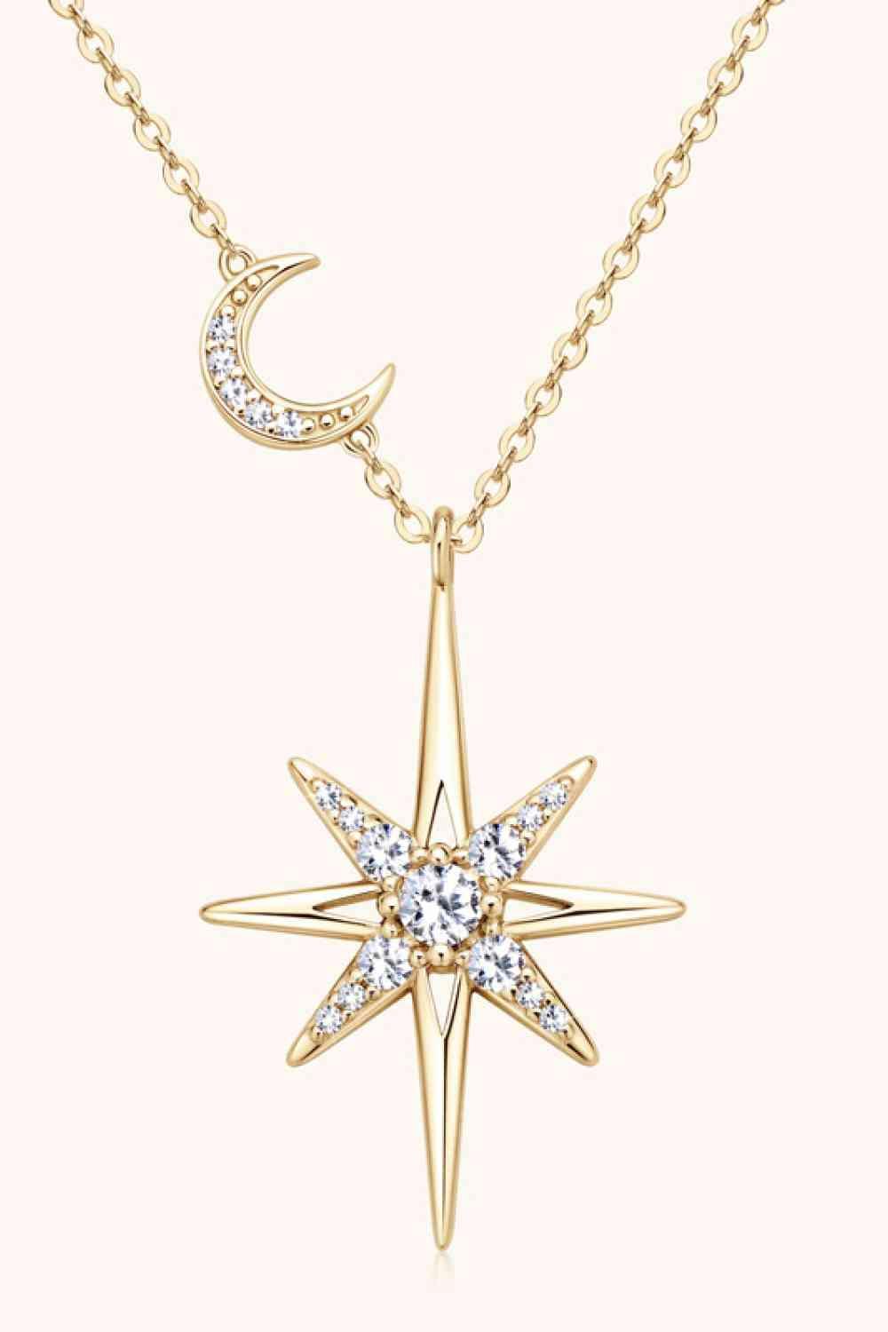 a gold necklace with a star and moon