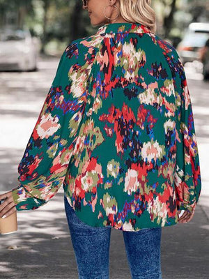 a woman wearing a green floral blouse and jeans