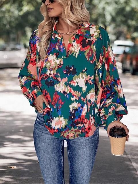 a woman wearing a green floral blouse and jeans