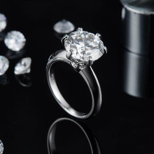 a close up of a diamond ring on a table