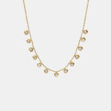 a gold necklace with small diamonds on a white background