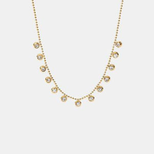 a gold necklace with small diamonds on a white background