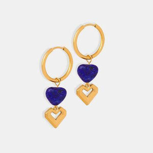 a pair of gold hoop earrings with blue stones