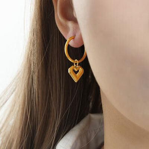 a close up of a person wearing a pair of earrings