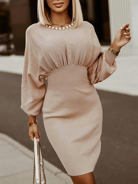 a woman in a beige dress is walking down the street