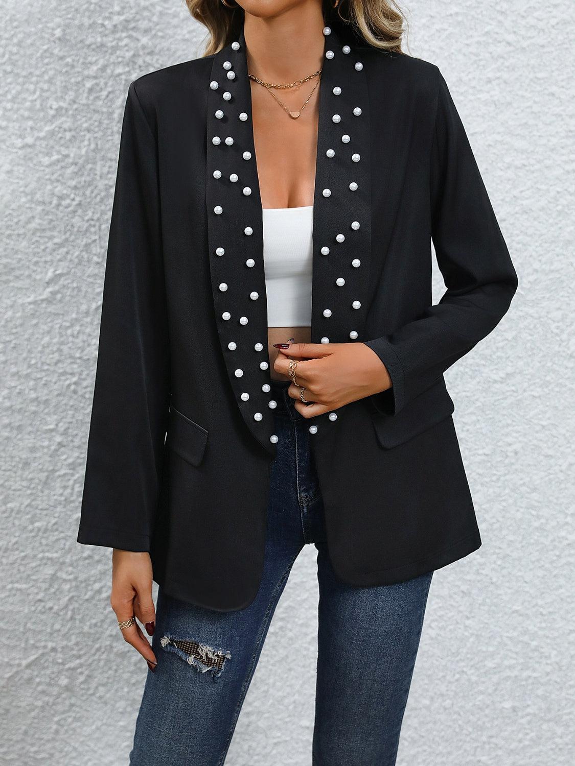a woman wearing a black jacket with white polka dots