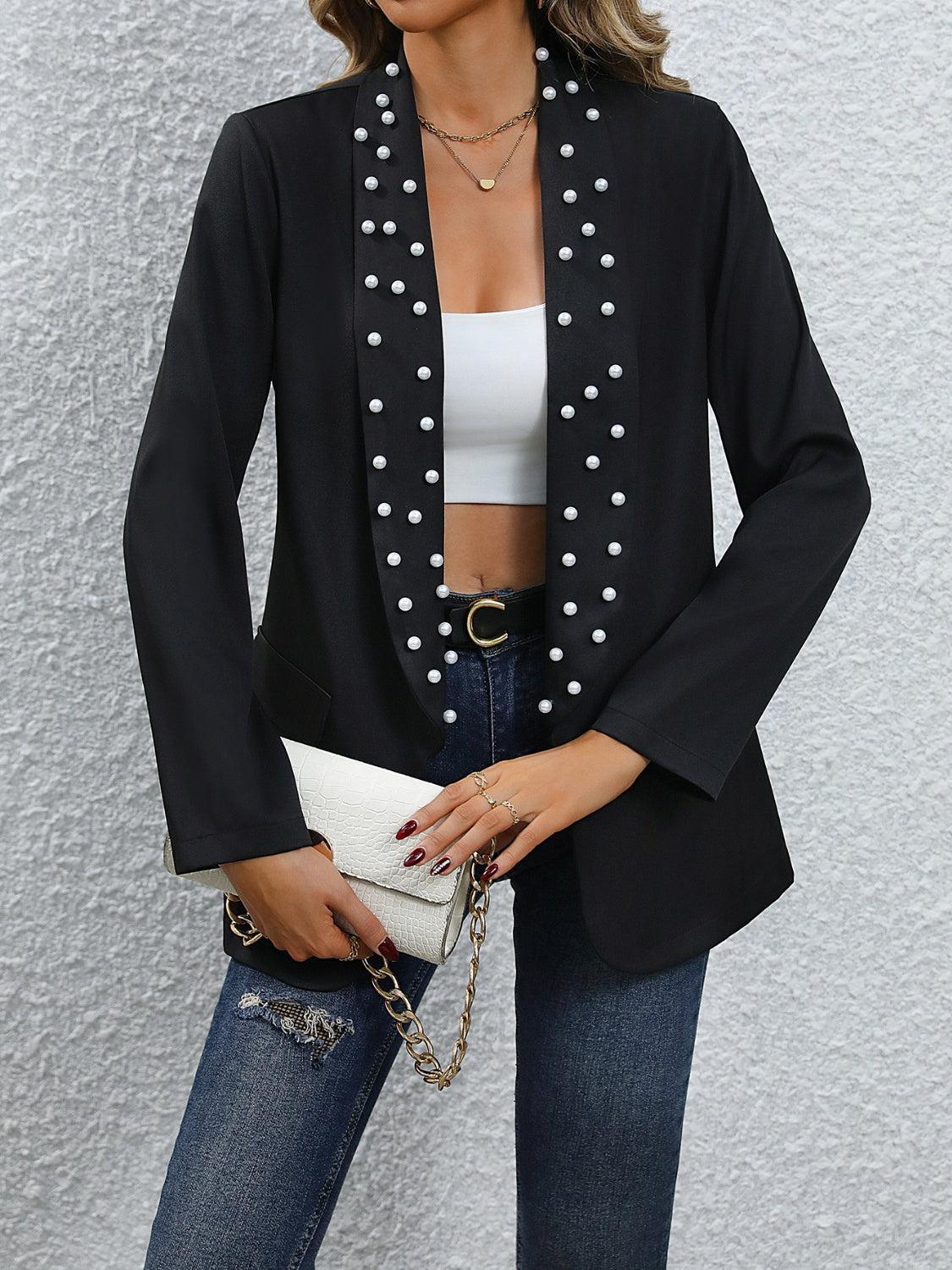 a woman wearing a black jacket and white top