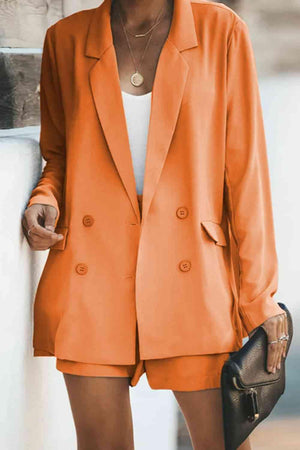 a woman wearing an orange blazer and shorts