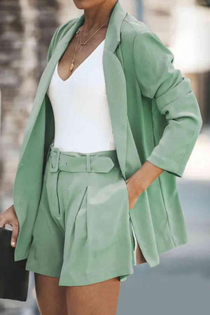 a woman wearing a green blazer and shorts