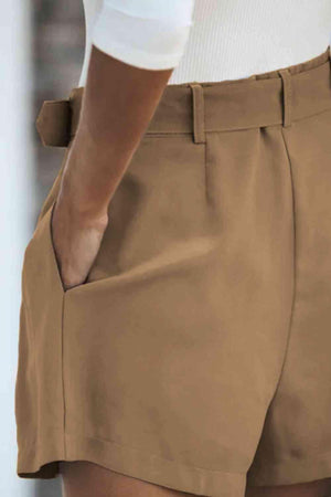 a close up of a person's pants with their hands in their pockets