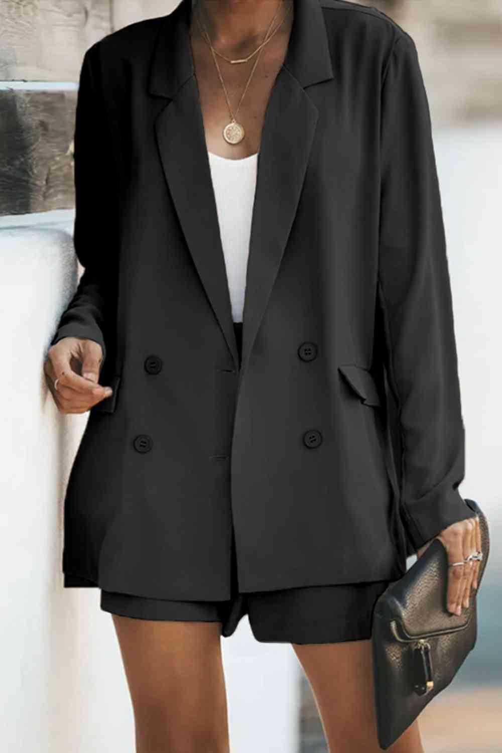 a woman wearing a black blazer and shorts