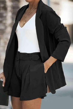 a woman wearing a black blazer and shorts