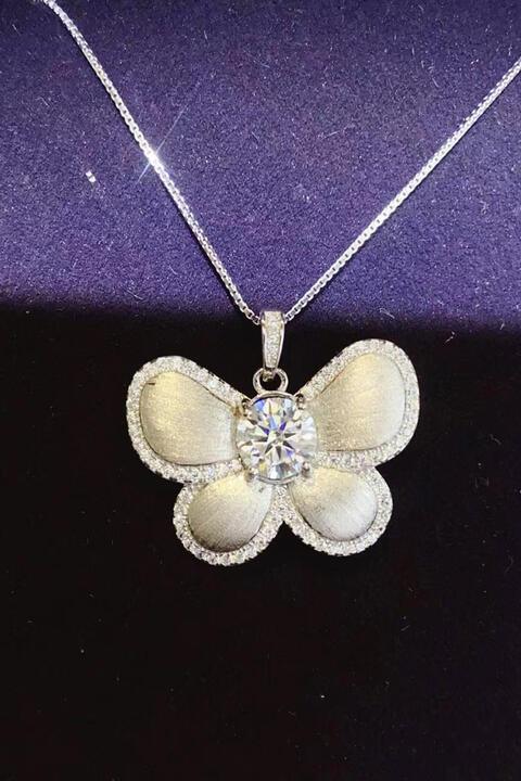 a necklace with a flower and a diamond on it