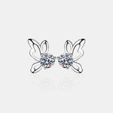 a pair of earrings with butterfly wings