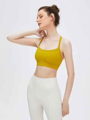 a woman in a yellow top and white pants