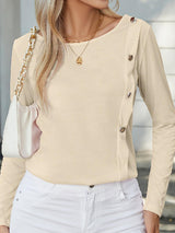a woman in white jeans and a beige top