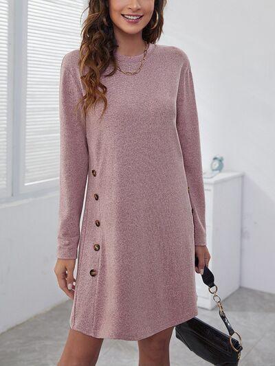 a woman in a pink sweater dress posing for a picture