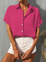 a woman wearing a pink shirt and white shorts