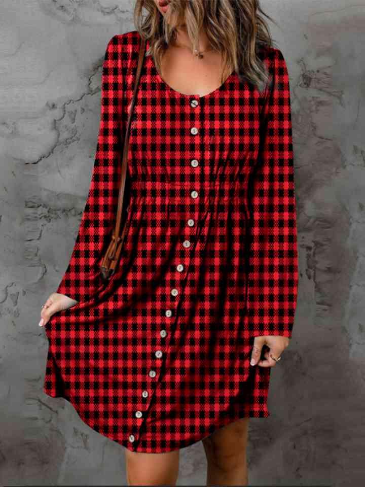 a woman wearing a red and black checkered dress