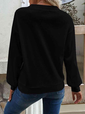 a woman wearing a black sweatshirt and jeans