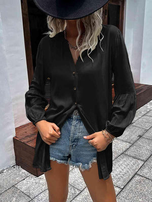 a woman wearing a black shirt and denim shorts