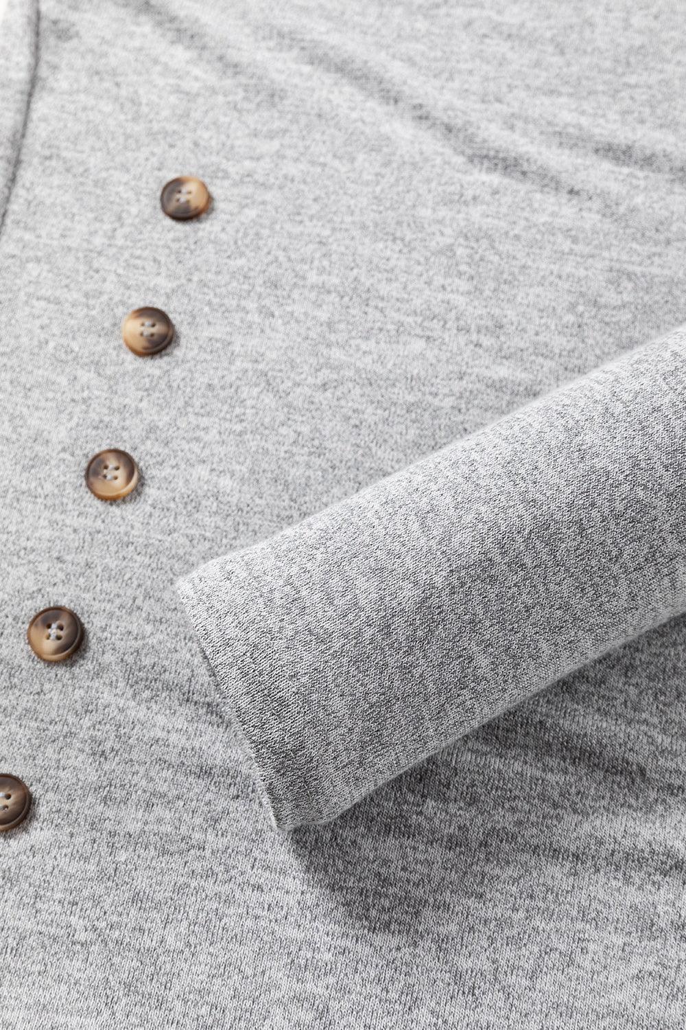 a close up of a sweater with buttons on it