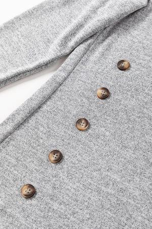 a close up of a sweater with buttons on it