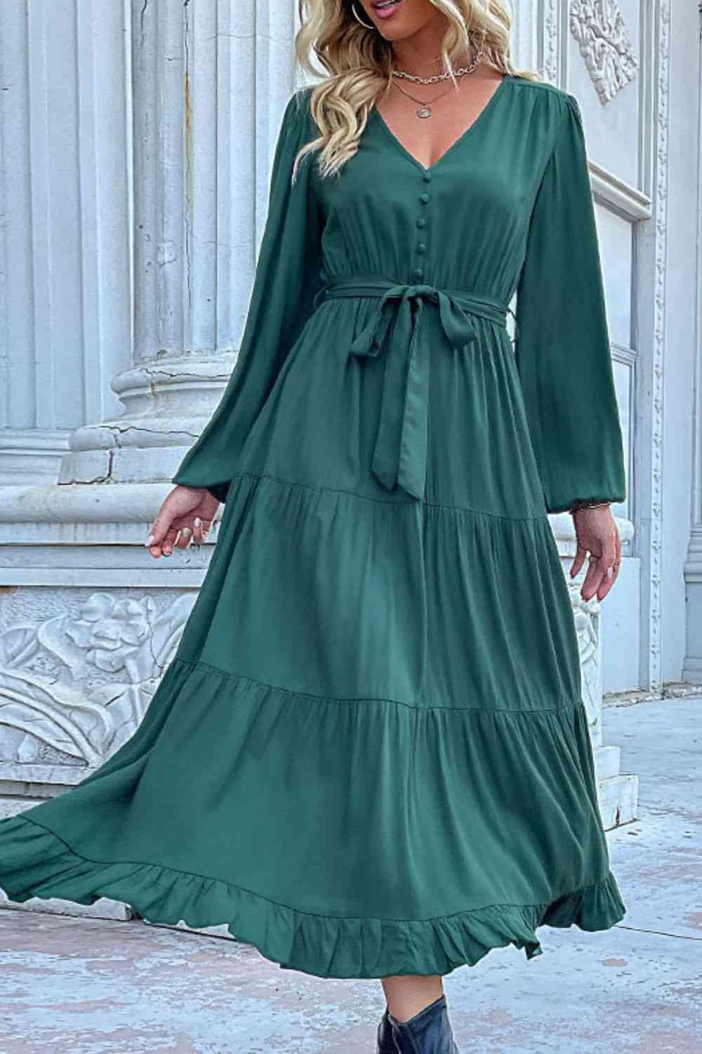 a woman wearing a green dress and cowboy boots