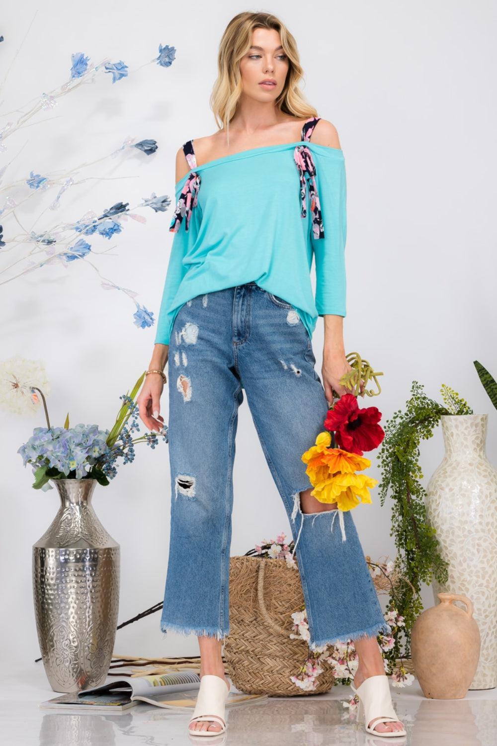 a woman standing in front of a bunch of flowers