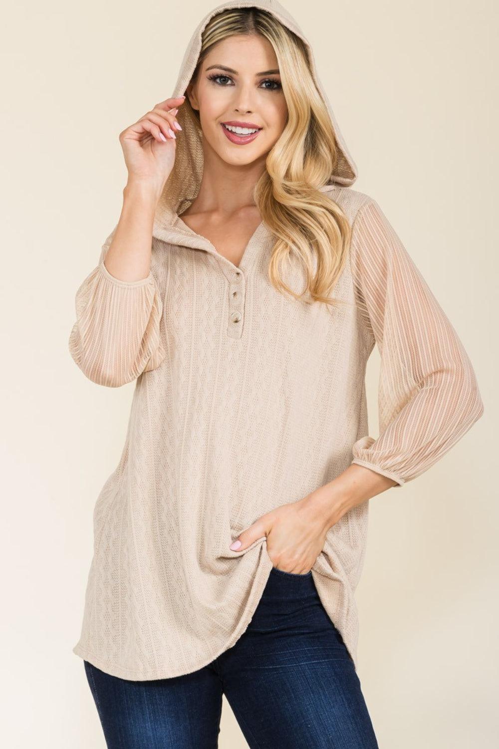 a woman wearing a beige sweater and jeans