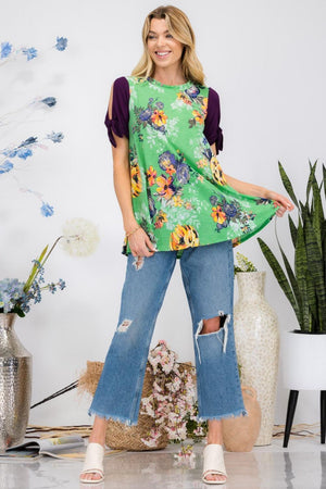 a woman standing in front of a plant