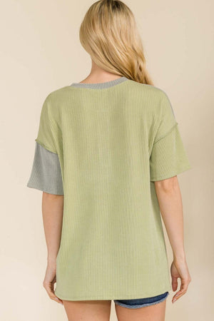 the back of a woman wearing a green top