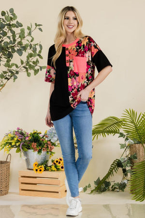 a woman standing in front of a potted plant