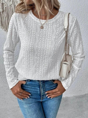 a woman wearing a white sweater and jeans