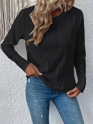 a woman wearing a black sweater and jeans