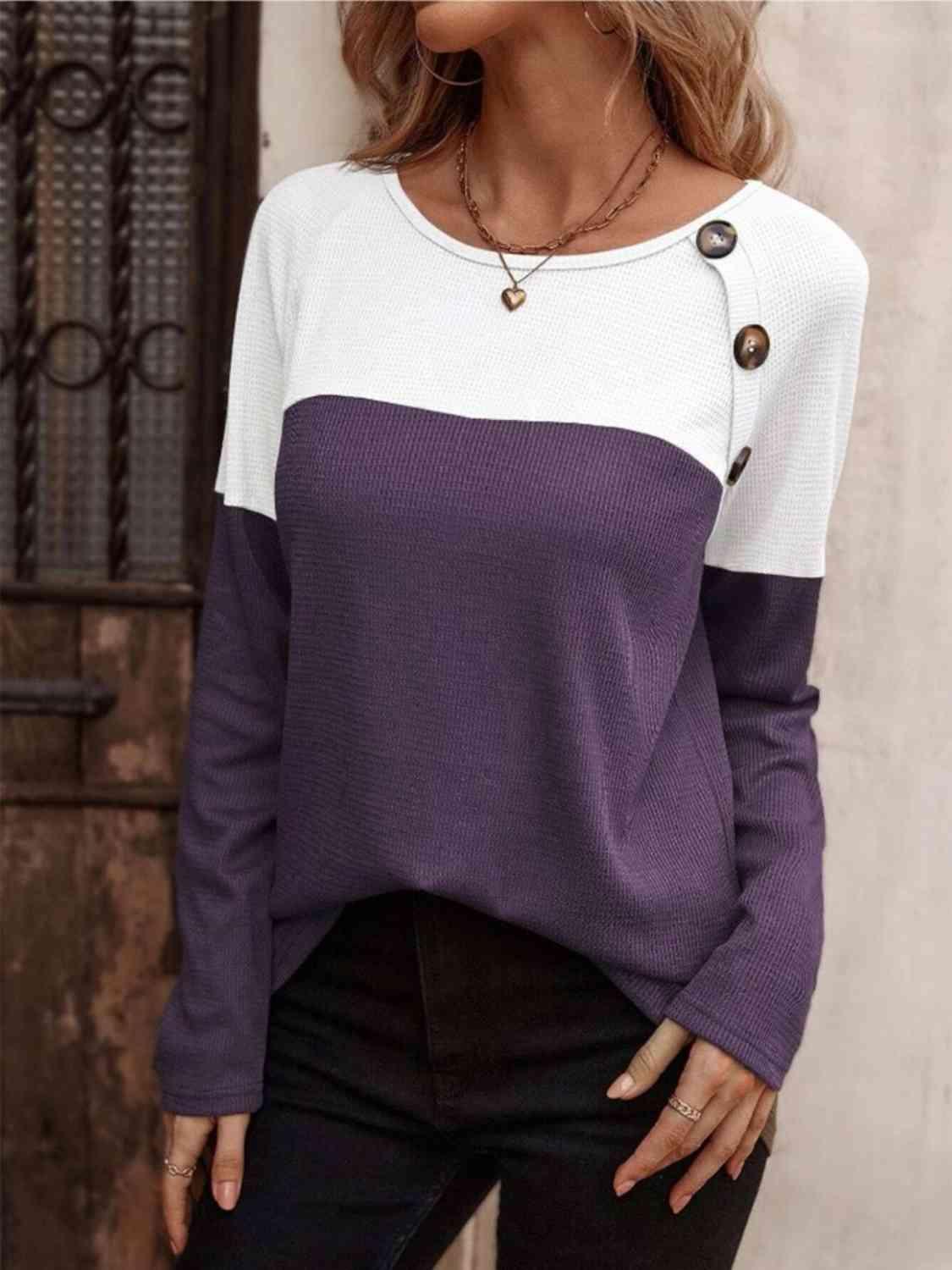 a woman wearing a purple and white sweater