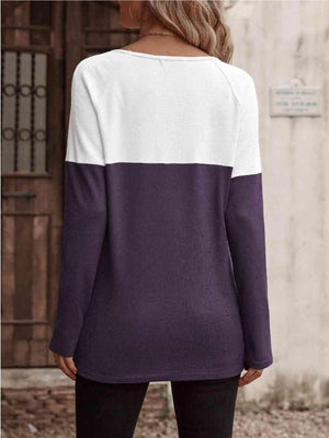 a woman wearing a purple and white sweater